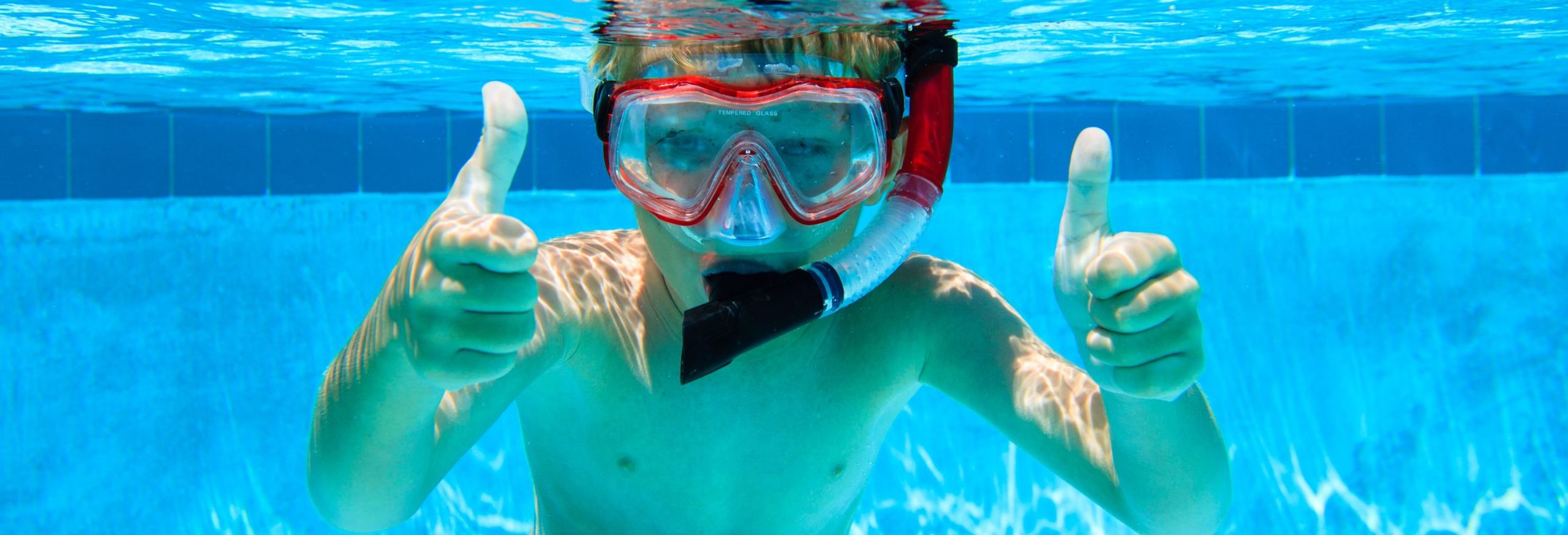 Happy,Boy,Swimming,Underwater,With,Thumbs,Up